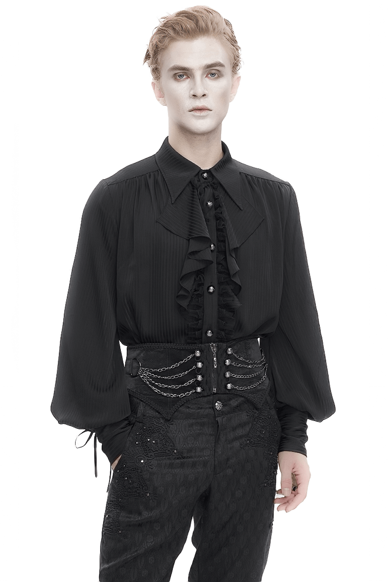 Gothic punk man wearing a black ruffled shirt and a multi-chain girdle, showcasing edgy fashion style.