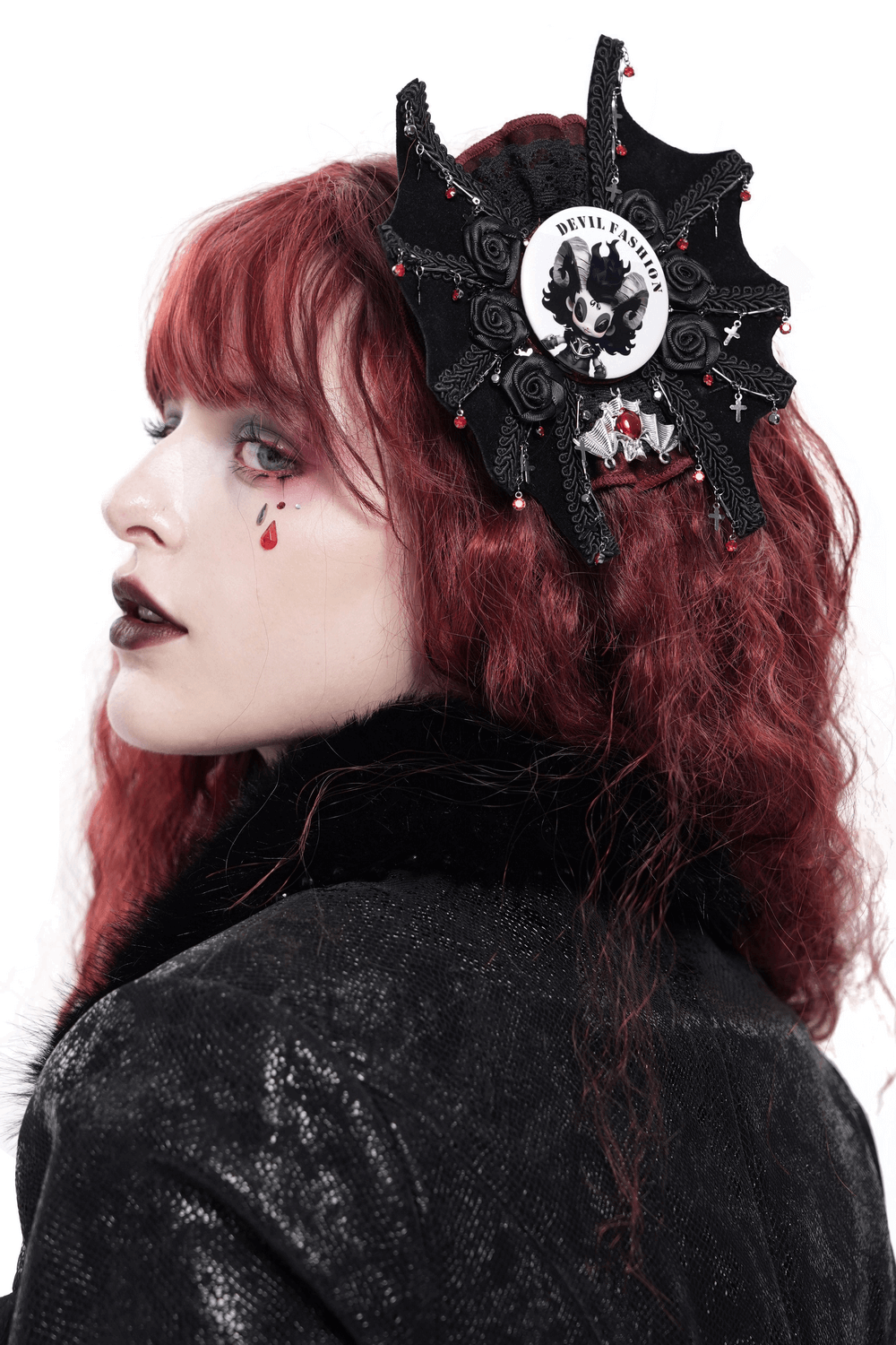 Gothic ram horn brooch pin in a dark fashion setting, adding a whimsical touch to a punk aesthetic.