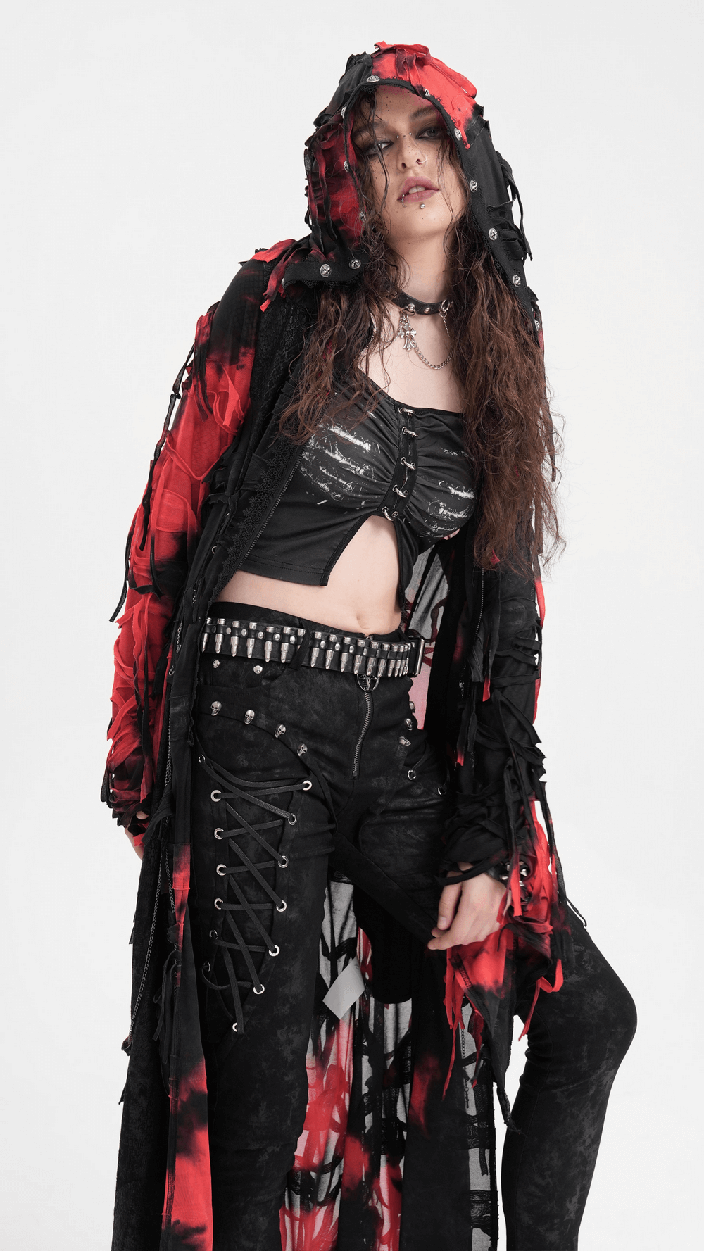 Model wearing a Gothic red and black hooded shredded cape paired with edgy black attire for a dramatic look.