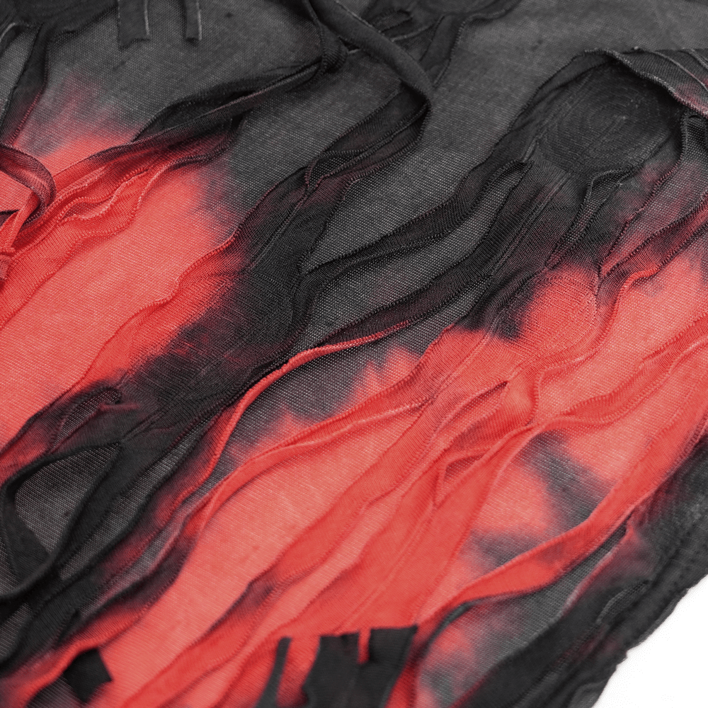 Close-up of gothic red and black tattered fabric showing a shredded design, perfect for a dark, edgy hooded cape.