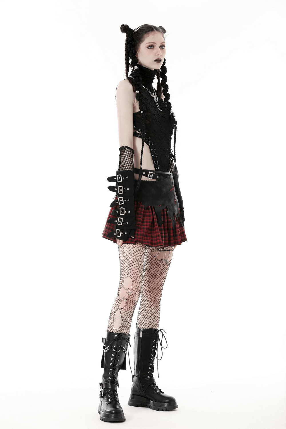 Model showcasing gothic red and black plaid skirt with cross detail, paired with combat boots and edgy accessories.
