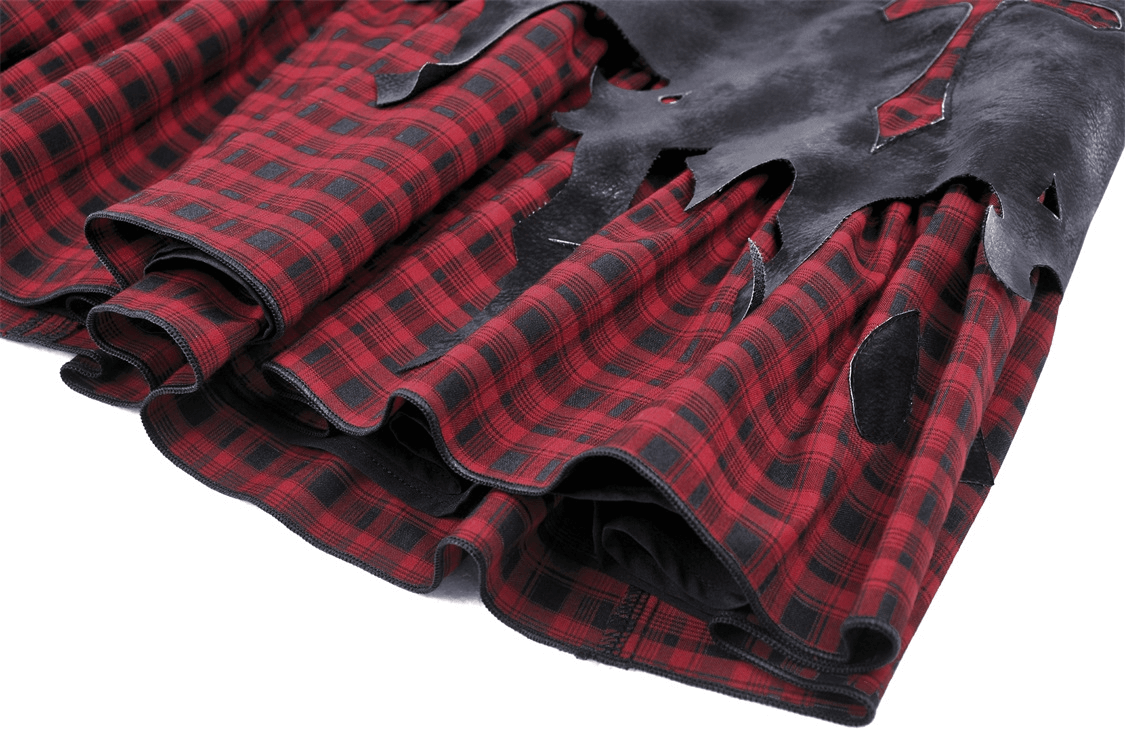 Gothic red and black plaid skirt with faux leather detail, showcasing edgy punk rock styling.