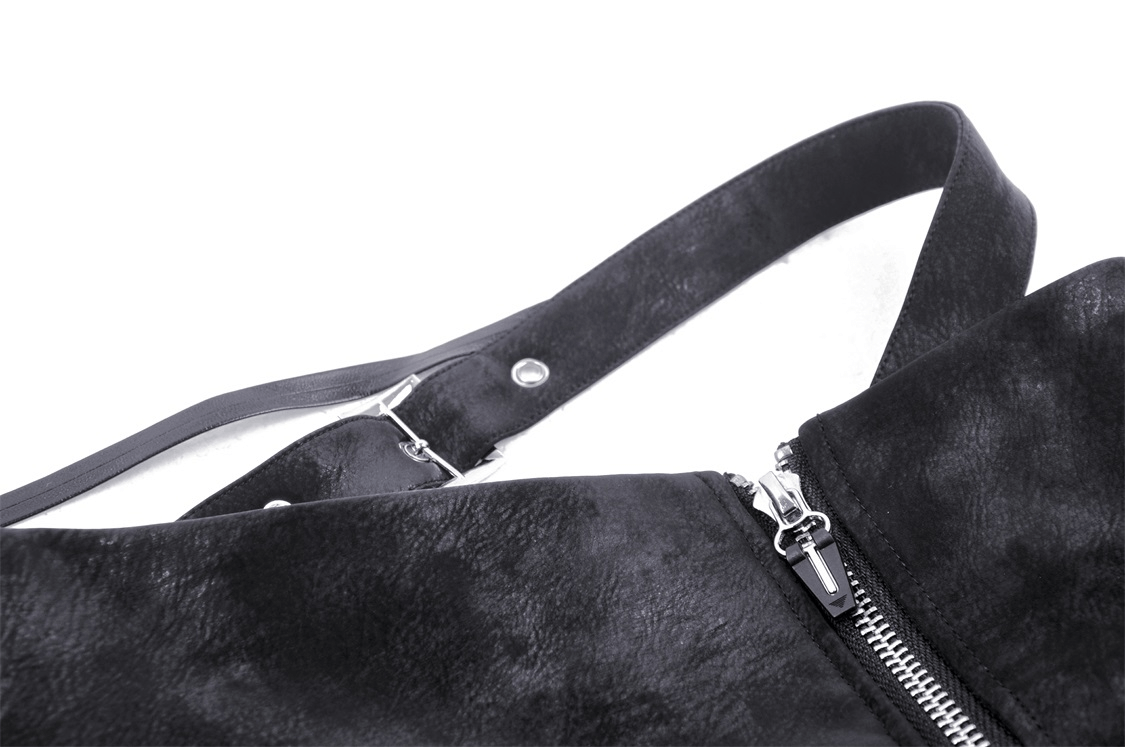 Close-up of a black faux leather bag with zipper detail and adjustable strap.