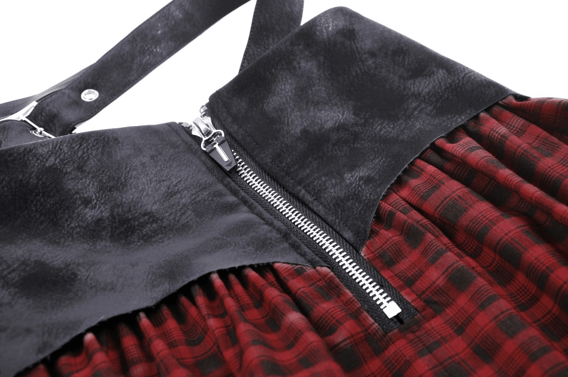 Close-up of gothic red and black plaid skirt featuring faux leather top and zipper detail.