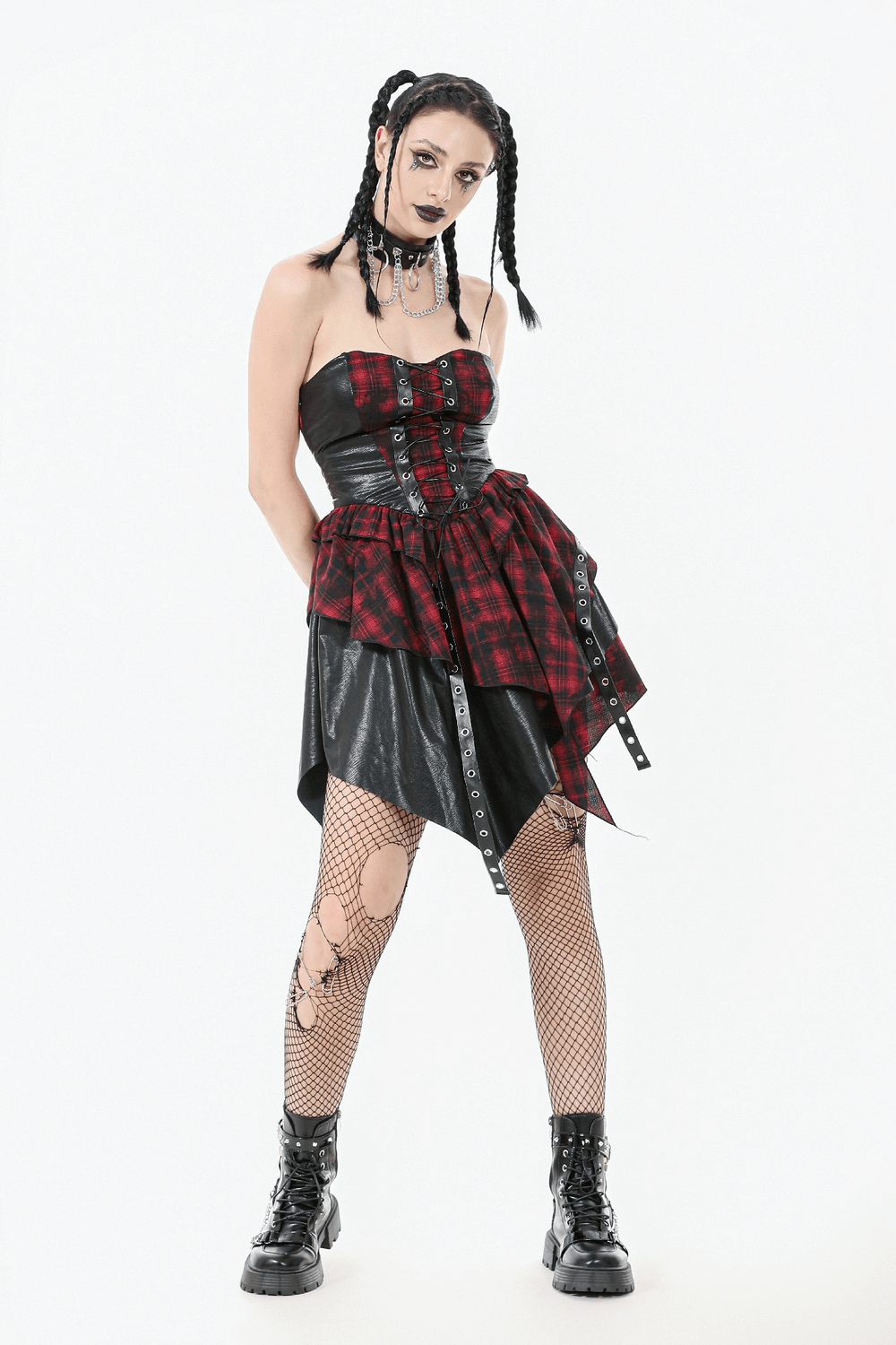 Gothic red plaid and leather dress with lace-up details, paired with fishnet stockings and edgy accessories.