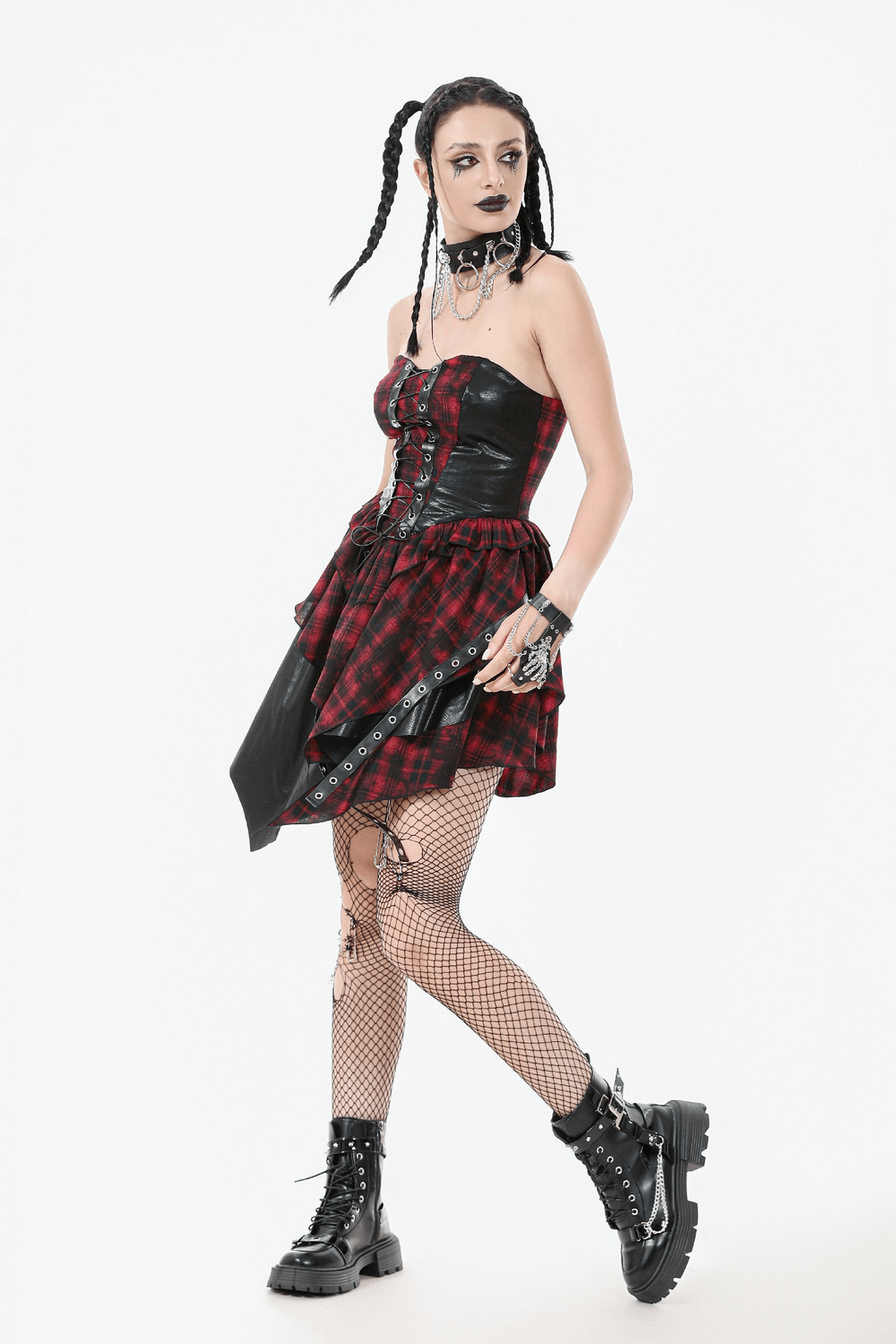 Gothic red plaid and leather dress featuring lace-up details, fishnet tights, and punk-inspired accessories.