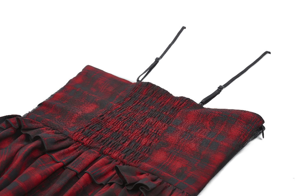 Close-up of Gothic red plaid and leather dress featuring lace-up details and adjustable straps.