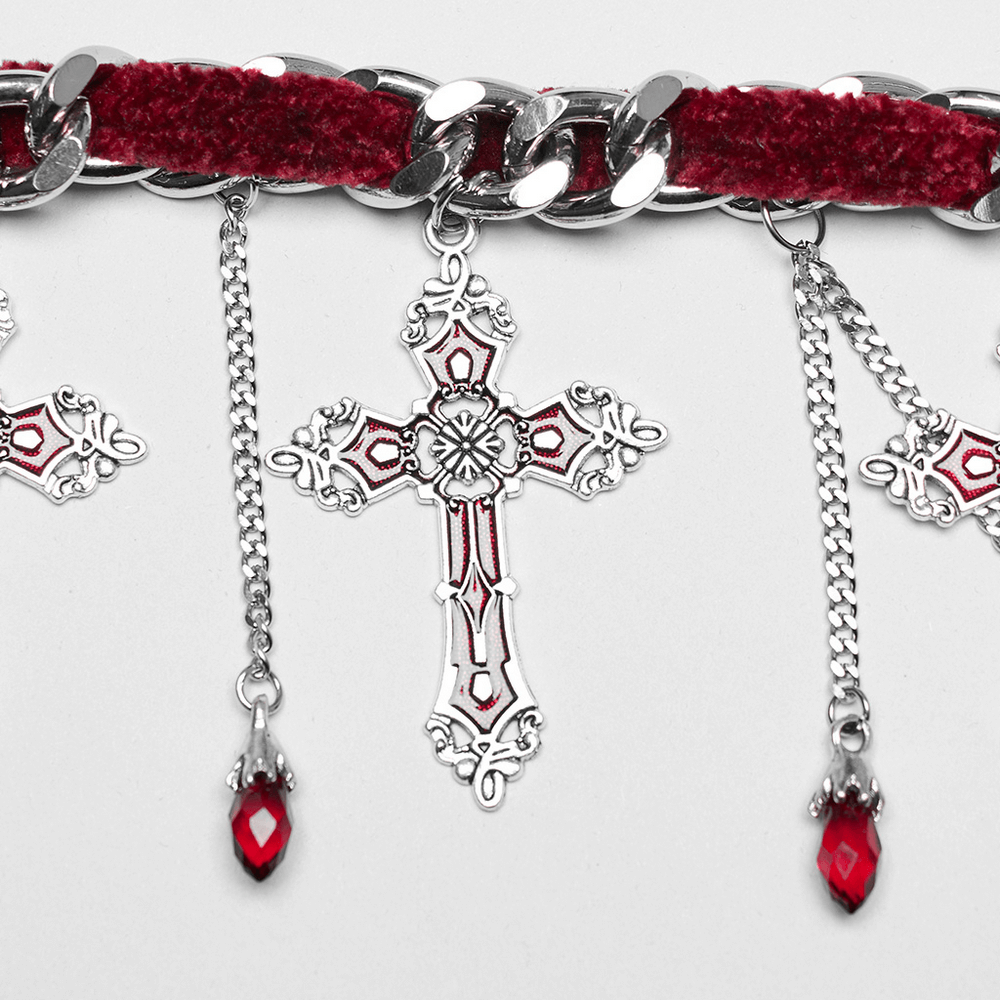 Gothic red velvet choker necklace with silver cross and tassels, perfect for a bold fashion statement.
