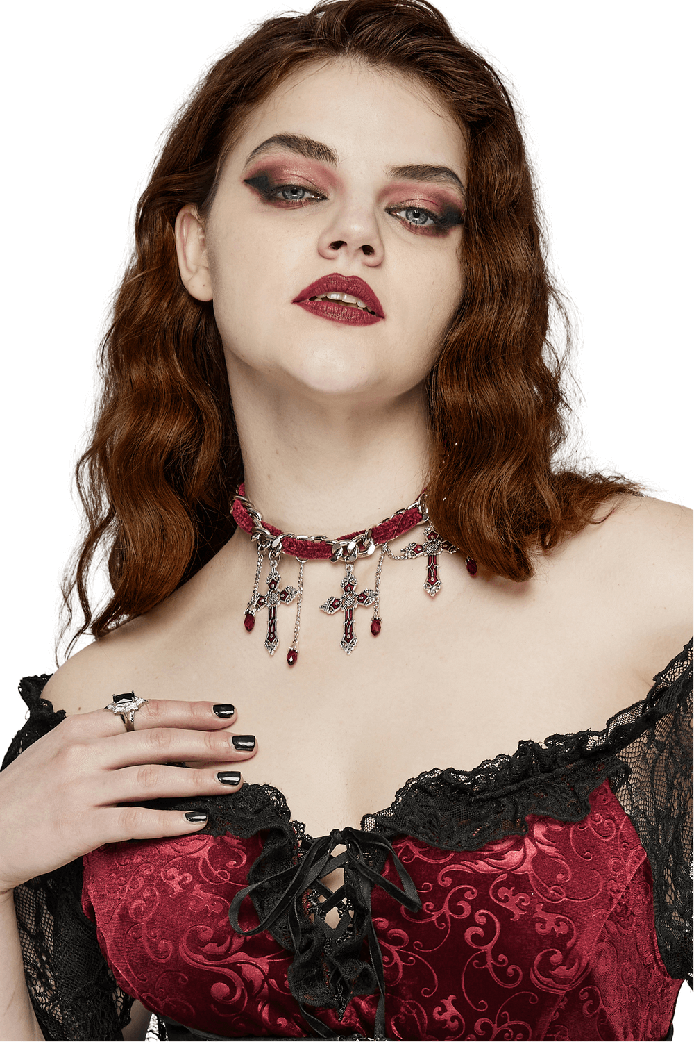 Elegant gothic red velvet choker necklace with cross pendants and tassels, accessorizing a stunning look.