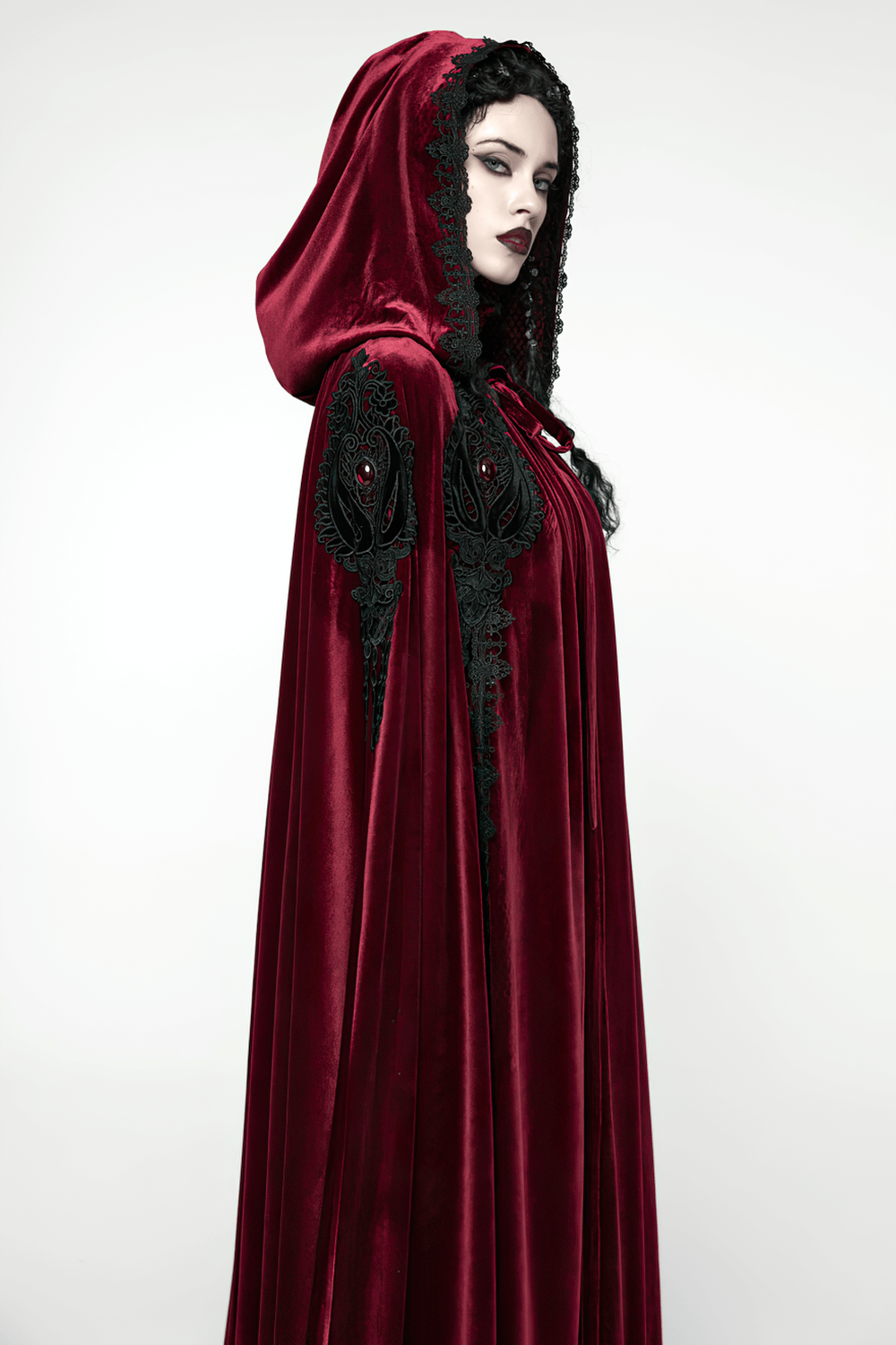 Gothic Red Velvet Hooded Cloak with Black Lace Trim worn elegantly, featuring intricate lace and embroidered appliques.