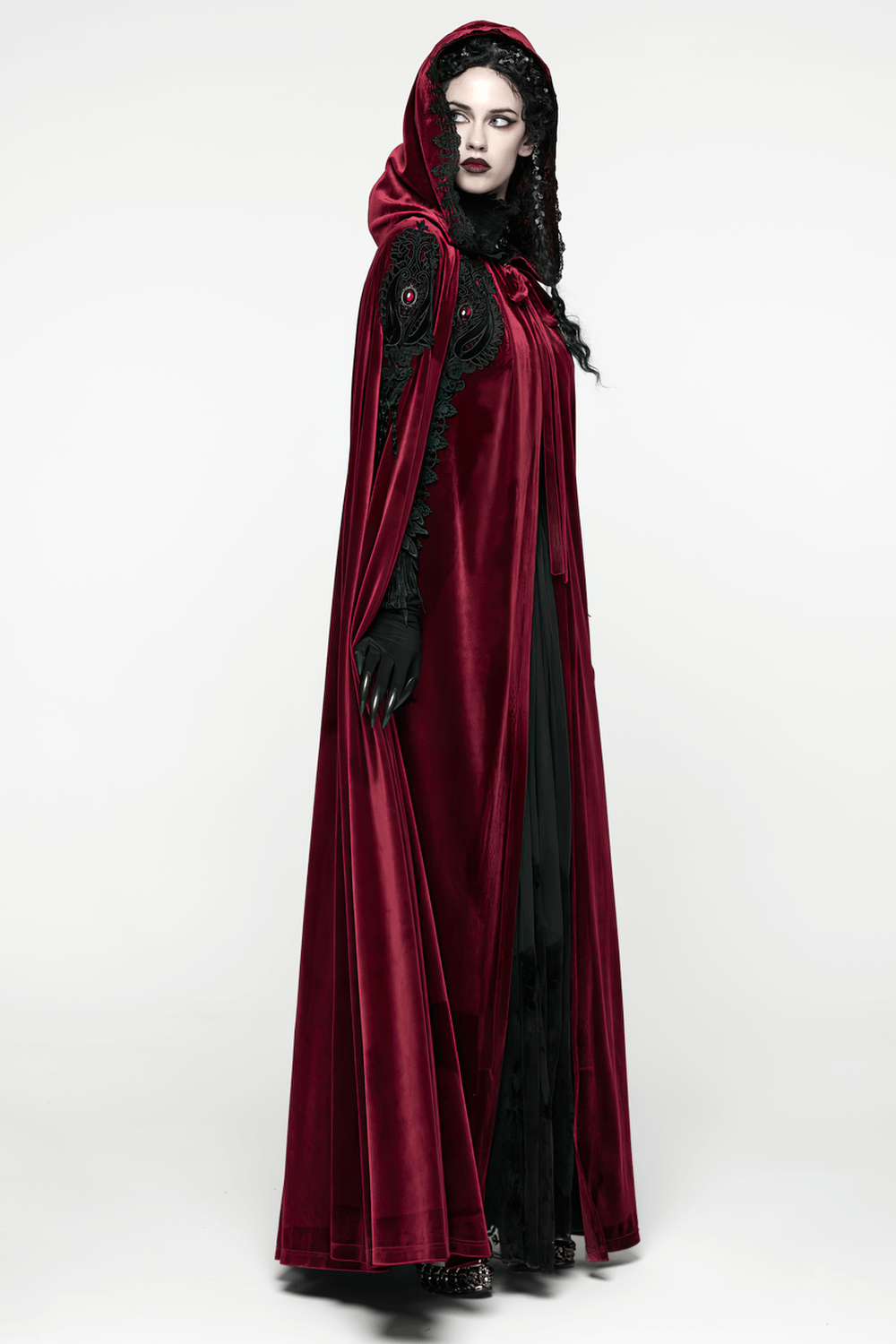 Gothic Red Velvet Hooded Cloak with Black Lace Trim elegantly draping on a model, showcasing intricate lace and velvet features.
