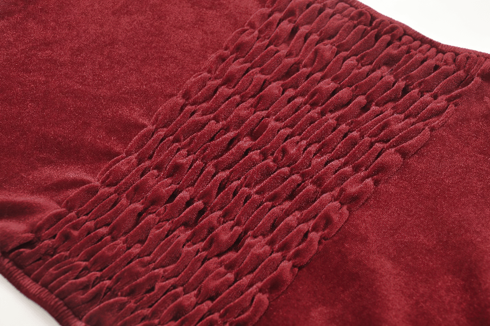 Close-up of rich red velvet fabric with textured gathers, perfect for gothic fashion enthusiasts.