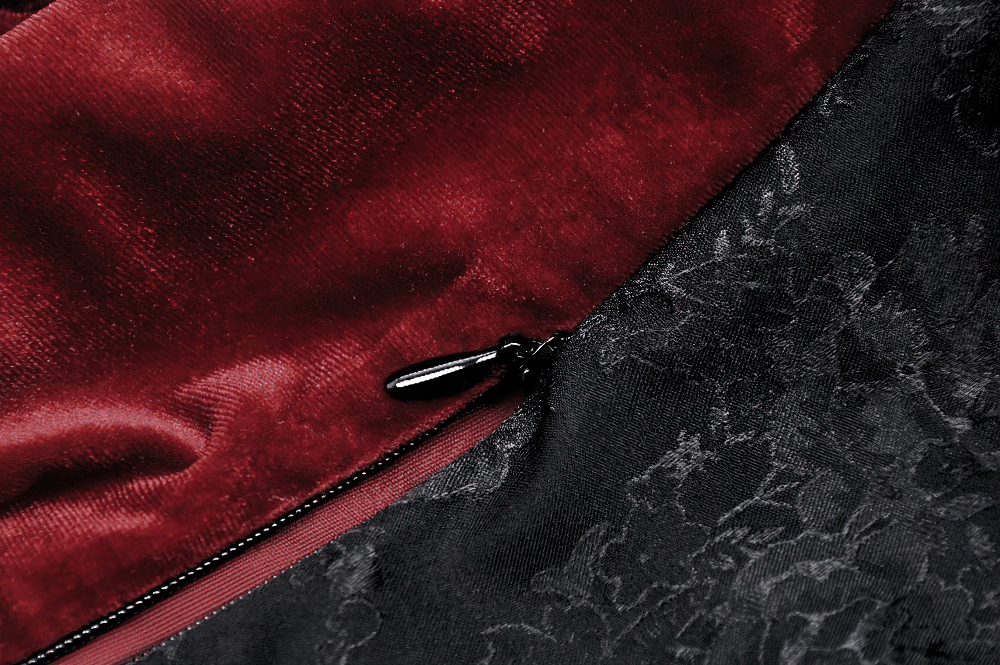 Close-up of gothic red velvet and black lace fabric with zipper, showcasing Victorian-inspired details.