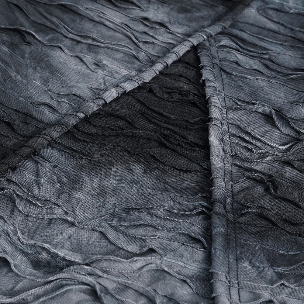 Close-up of textured fabric, showcasing the unique ruffled design of a gothic hoodie.