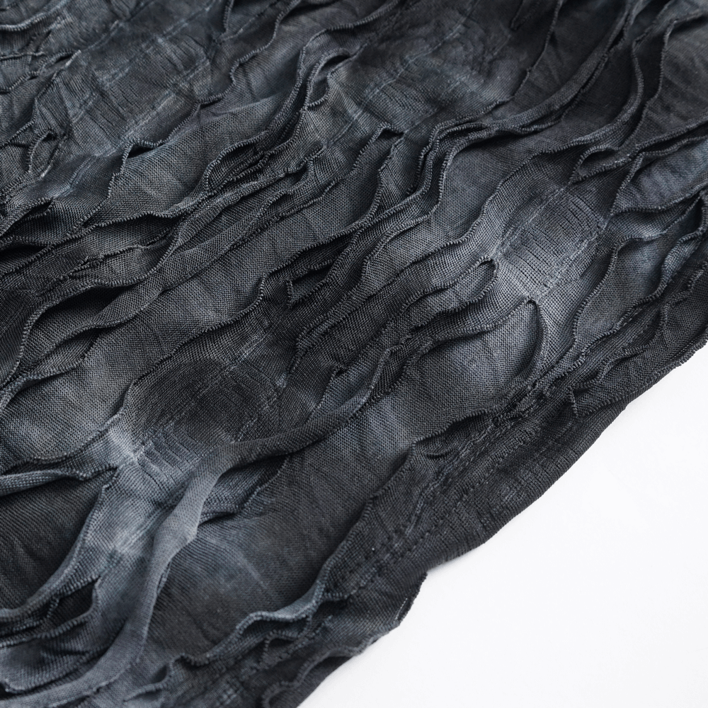 Close-up of gothic ripped fabric with textured waves, showcasing the unique design of an edgy hoodie.