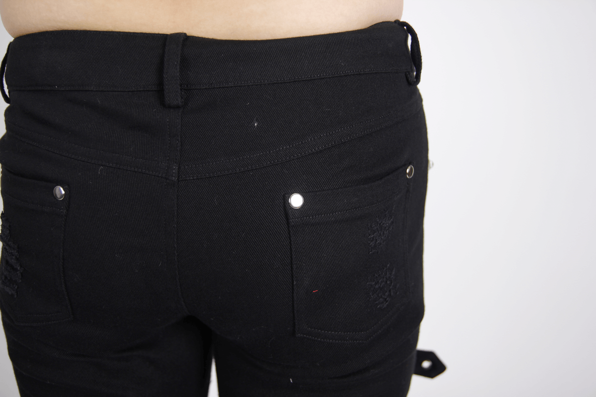 Close-up view of Gothic ripped black trousers with buckles, showcasing the stylish back pockets and form-fitting silhouette.