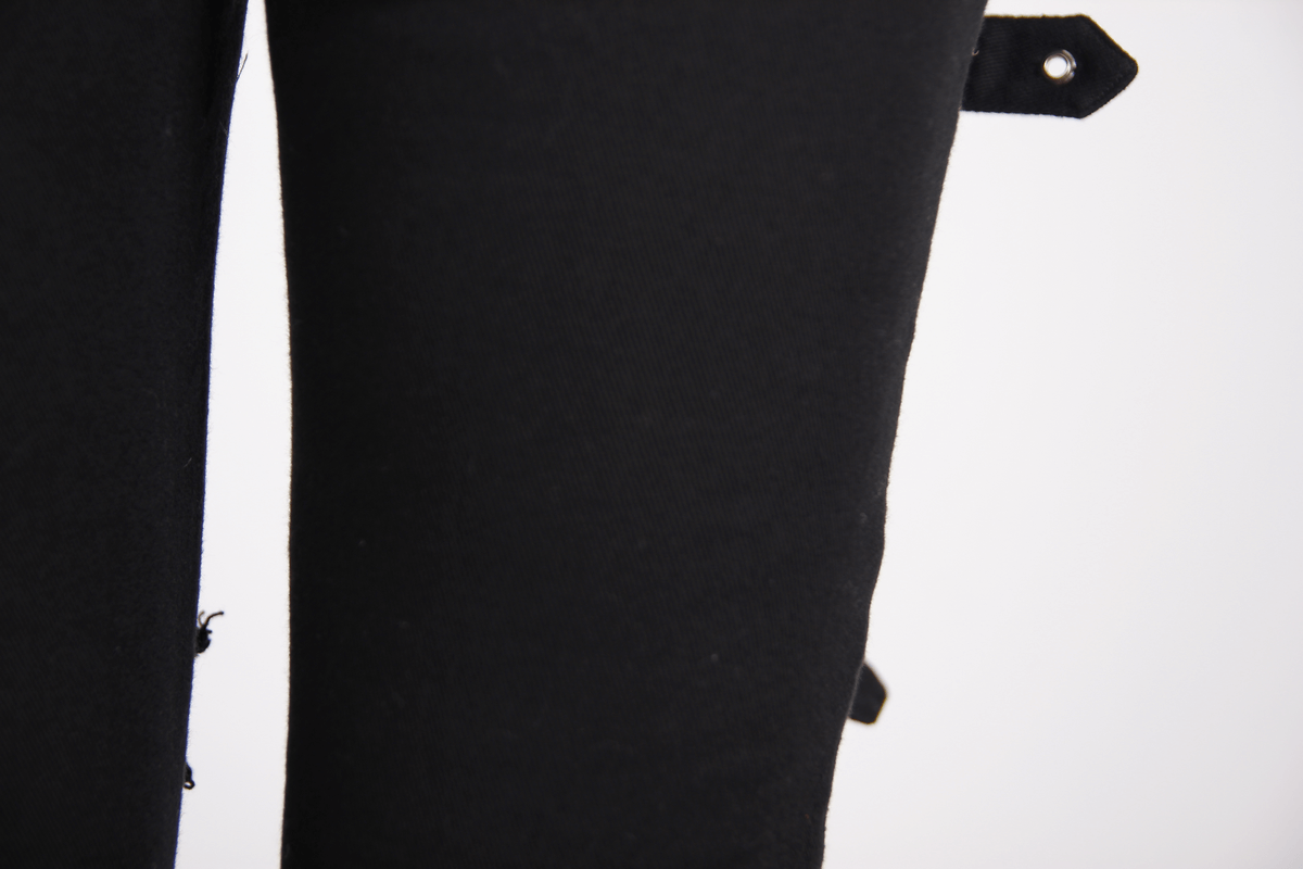 Close-up of Gothic ripped black pants featuring buckles and a stylish form-fitting design for a steampunk look.