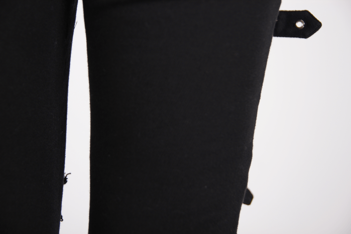 Close-up of Gothic ripped pants featuring buckles and torn inserts, showcasing a stylish steampunk design for women.