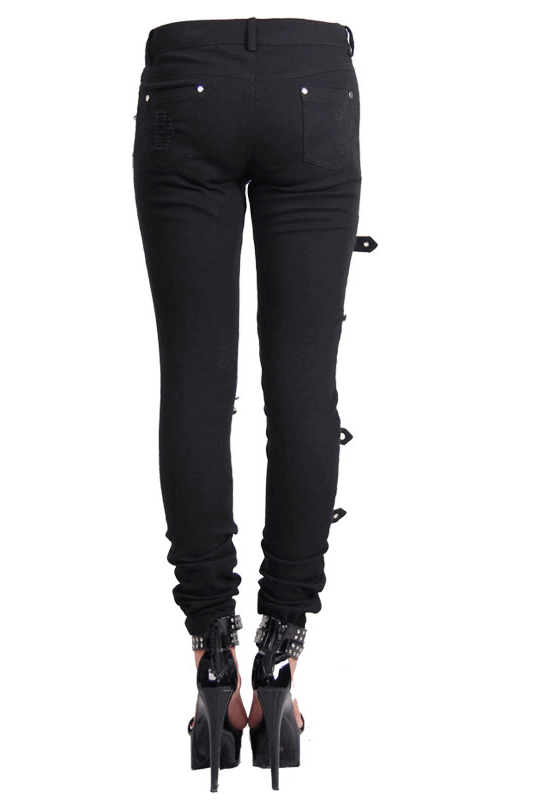 Women's Gothic ripped black trousers with buckles, showcasing steampunk style and form-fitting cut.