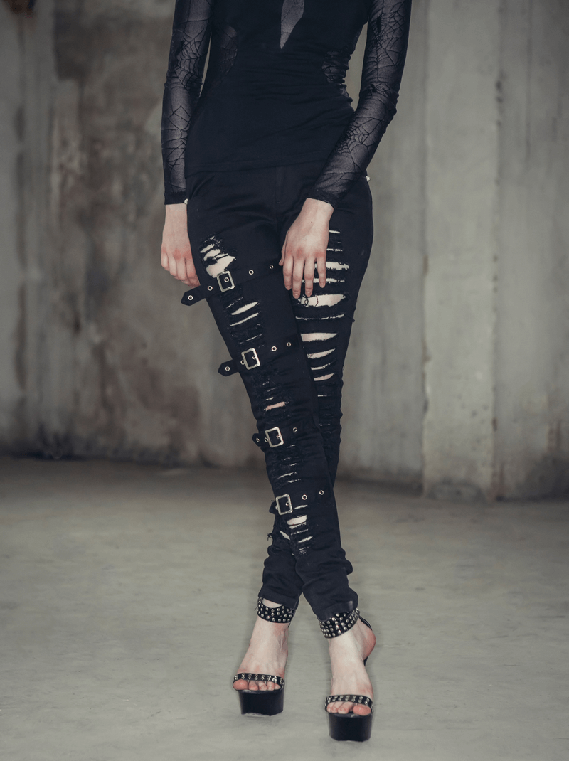 Gothic ripped pants with buckles worn by a model, showcasing a stylish steampunk look with torn details and buckle accents.