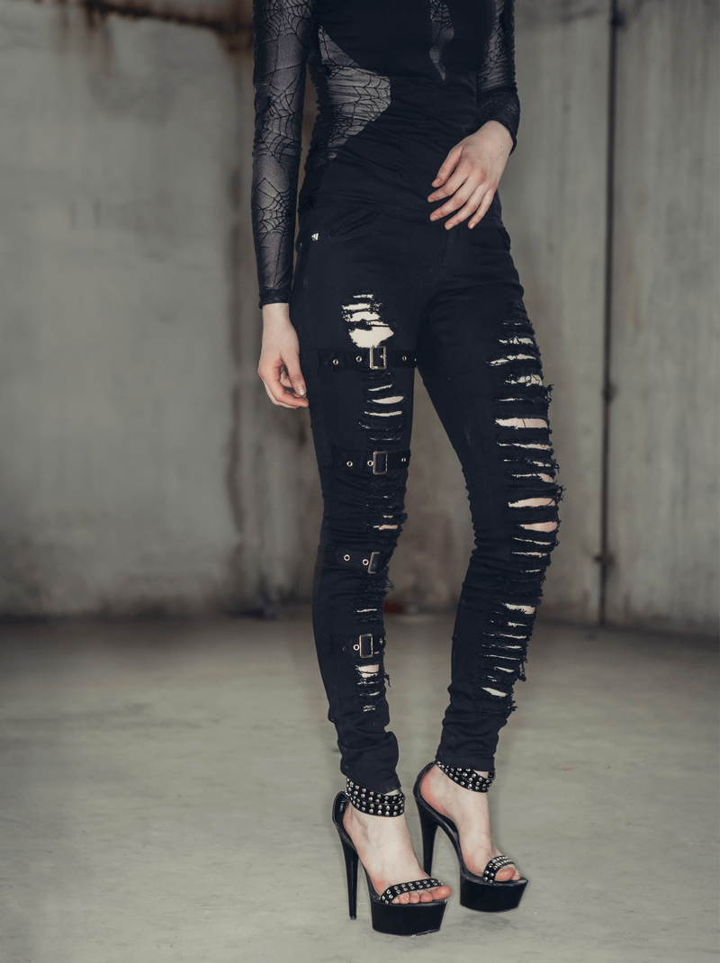 Gothic ripped black pants with buckles, showcasing a form-fitting style and trendy torn inserts.