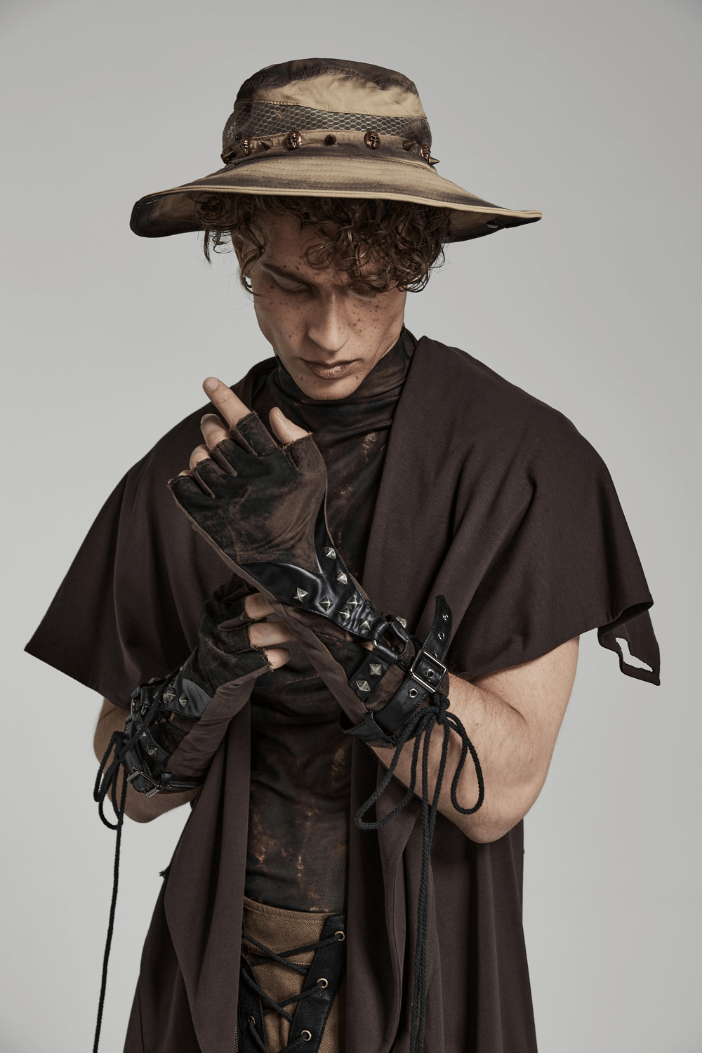 Man wearing Gothic rivet fingerless gloves, showcasing punk style with edgy design and unique accessories.