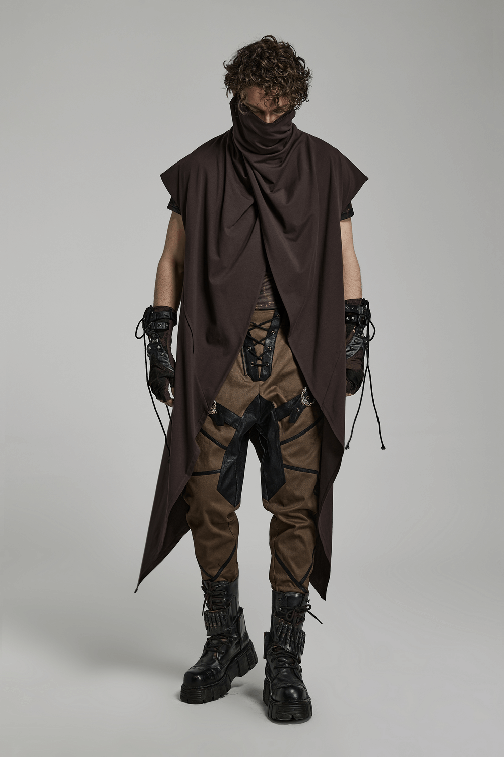 Model showcasing edgy Gothic attire with fingerless gloves, embodying punk and rebellious fashion.