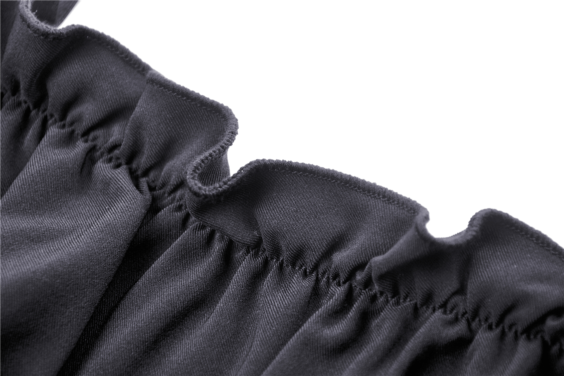Close-up of the elegant ruffled neckline of a black Gothic off-the-shoulder dress with lace sleeves.