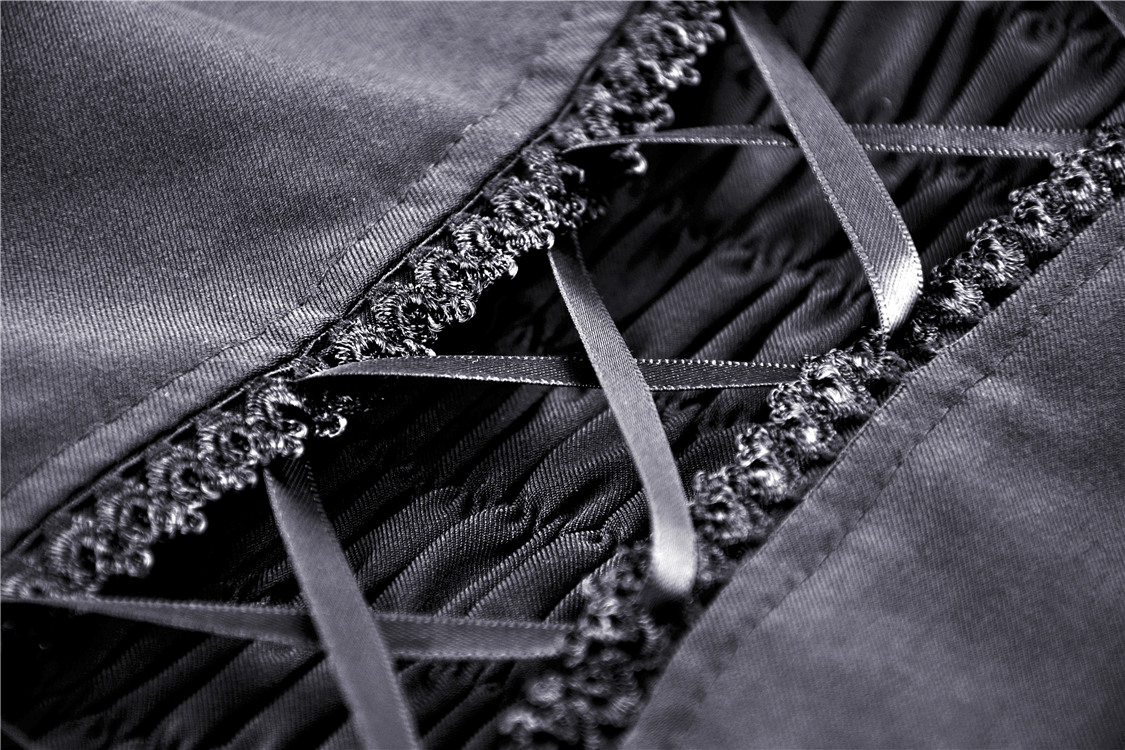 Close-up of the intricate lace and ribbon details on a gothic off-the-shoulder dress, showcasing elegant craftsmanship.