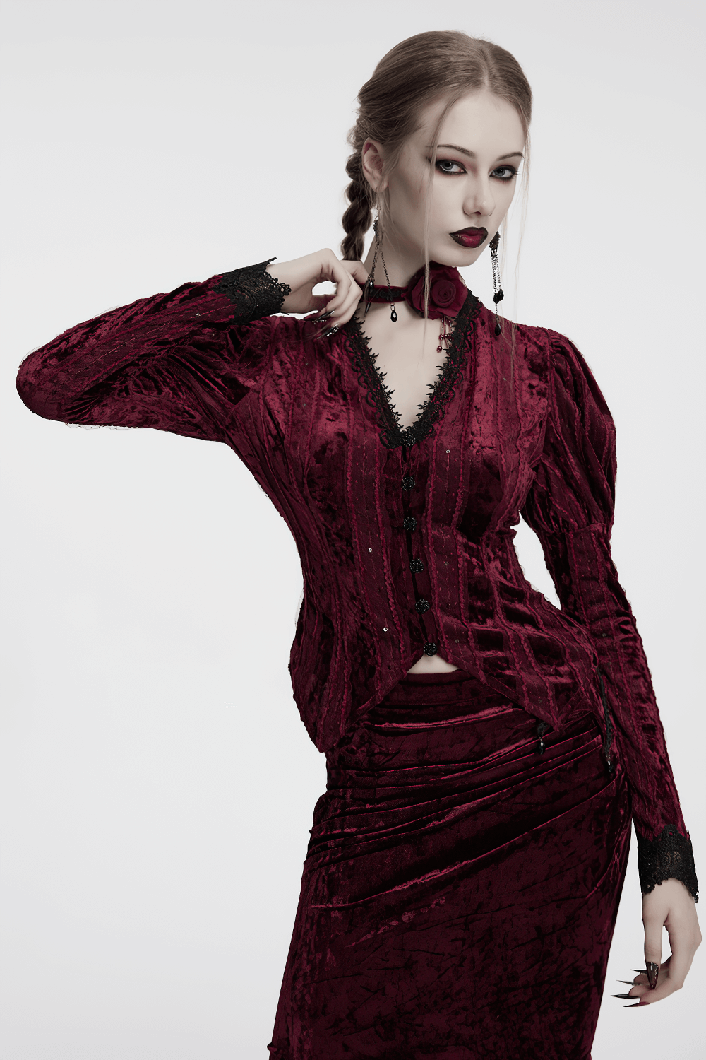 Elegant model in a rich crimson velvet dress and choker, showcasing gothic fashion with lace details.