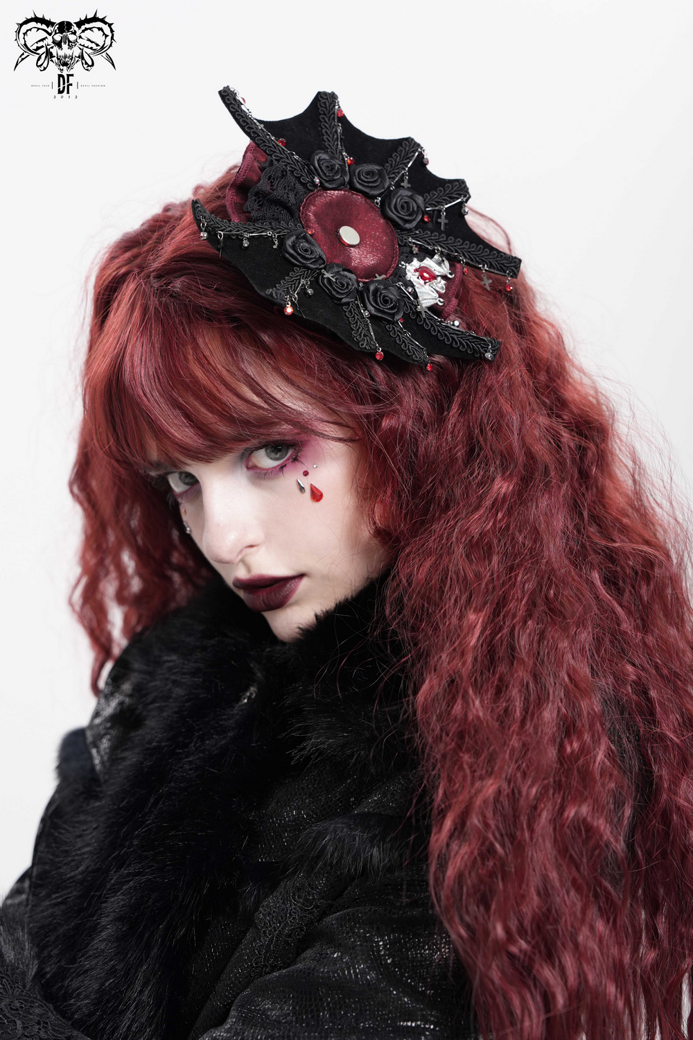 Gothic rose cross hair clip featuring spider web and skull detail, worn by model with red hair.