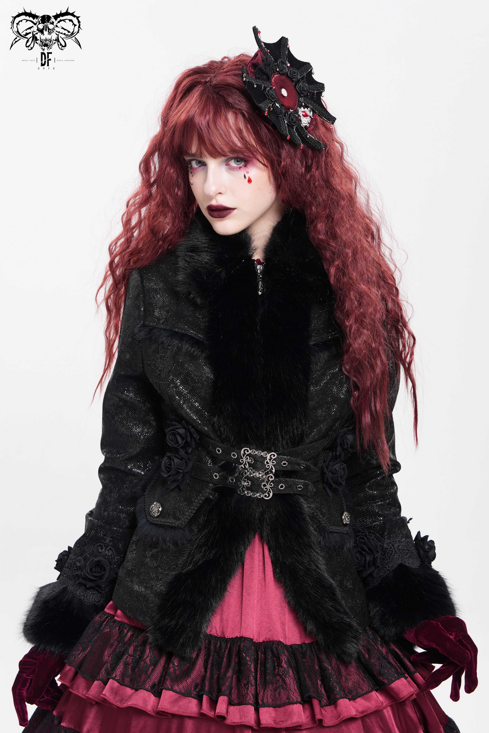 Gothic rose cross hair clip with spider web and skull detail, styled with dark fashion outfit.