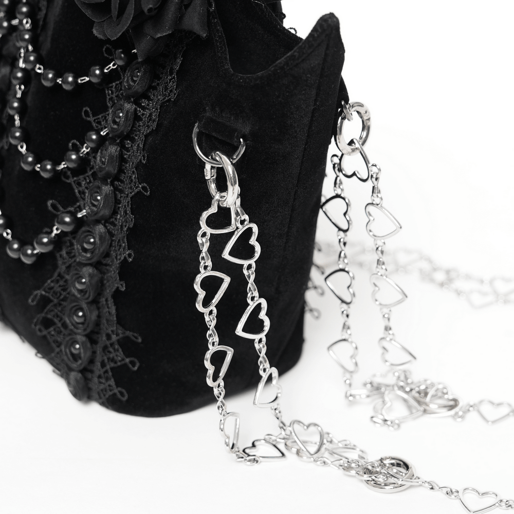 Alt Tag: Gothic Rose Velvet Handbag with Pearl Chains and Lace black velvet bag with lace trim, bead drape, and silver heart chain straps
