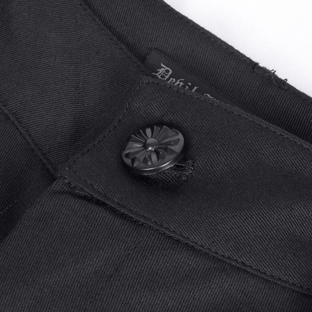 Close-up of Gothic ruched pants button and label, showcasing sleek black fabric and detailed craftsmanship.