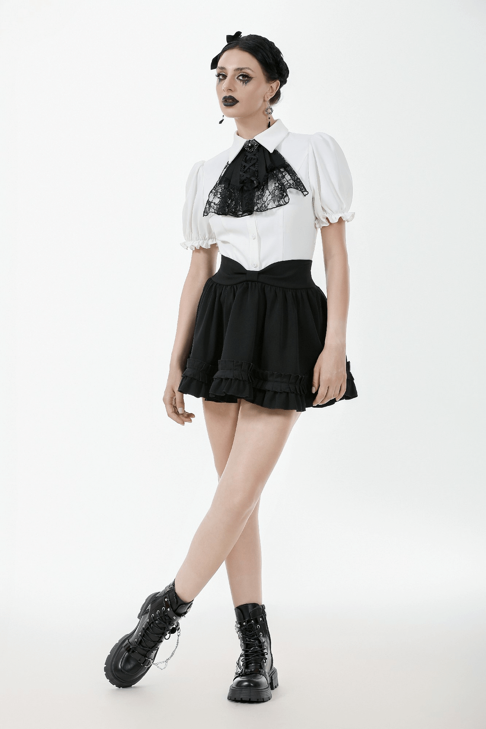 Gothic model in black ruffle mini skirt with satin layers, lace blouse, and chunky boots, showcasing Lolita style elegance.