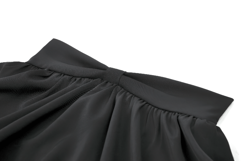 Close-up of the elegant black mini skirt with a bow and satin layers, showcasing ruffles and elastic waistband.