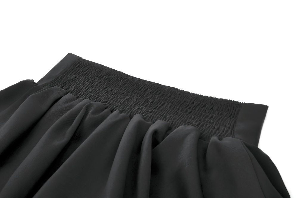 Close-up of the elastic waistband of a Gothic ruffle mini skirt, showcasing pleated detailing in elegant black satin.