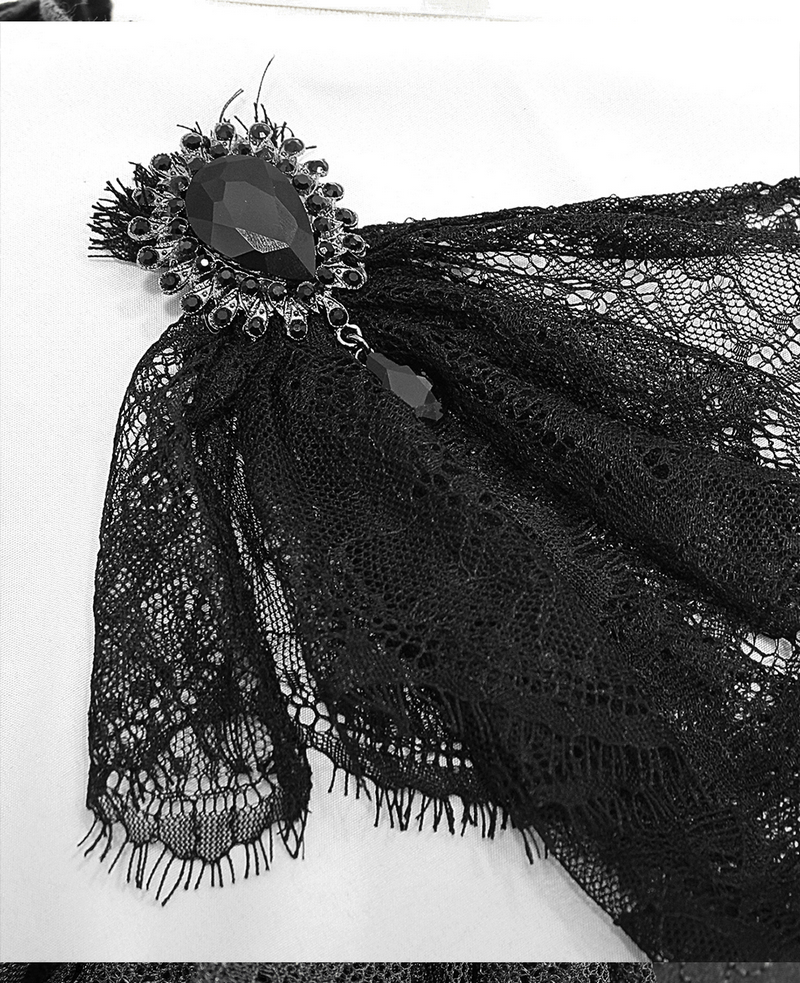 Close-up of a black lace bowtie with an elegant gemstone brooch, perfect for gothic-style outfits.