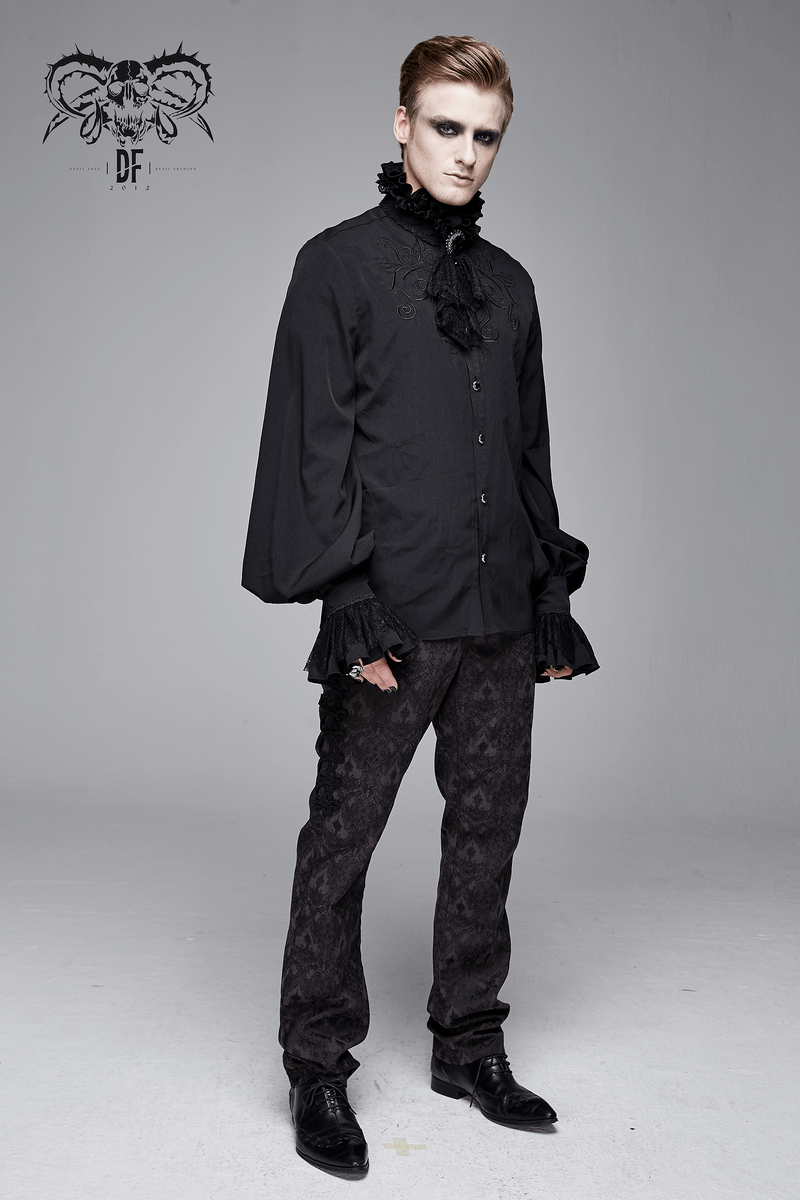 Stylish man wearing a gothic ruffled high collar black shirt with long sleeves and a lace bowtie.
