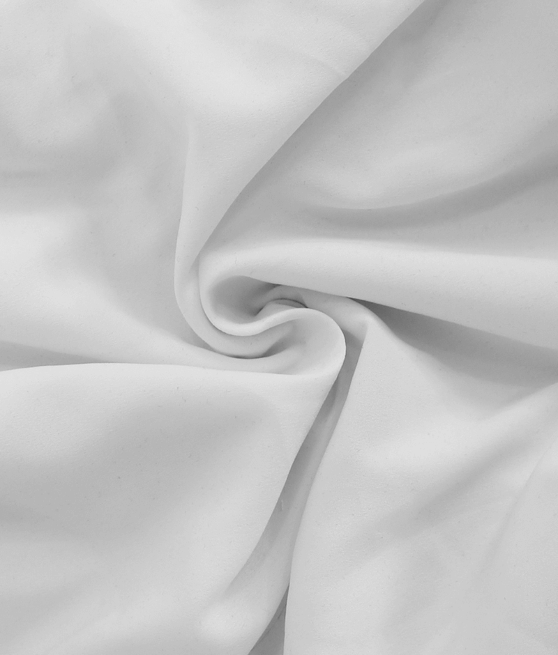 Soft white fabric in a swirling pattern, perfect for crafting stylish garments such as a vintage gothic shirt.