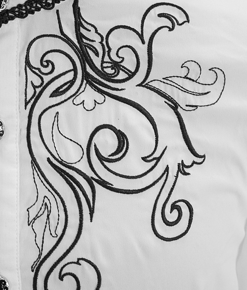 Close-up of intricate black embroidery on a white vintage gothic shirt, featuring floral and swirling designs.