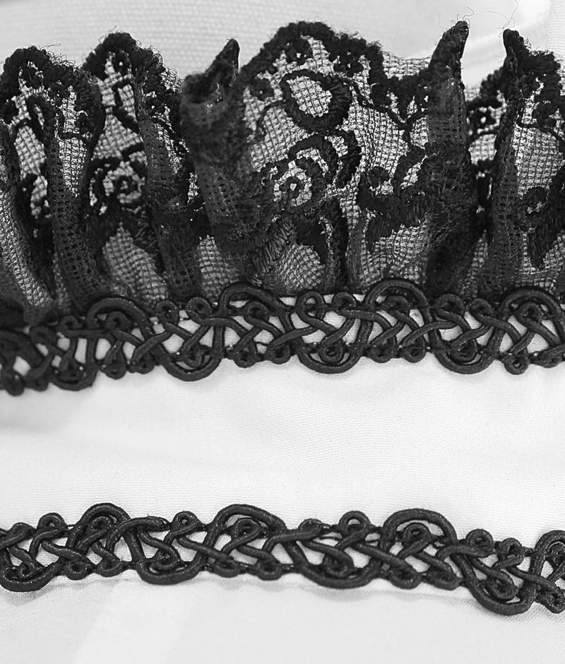 Close-up of black lace trim and intricate design on a gothic high collar shirt for men.