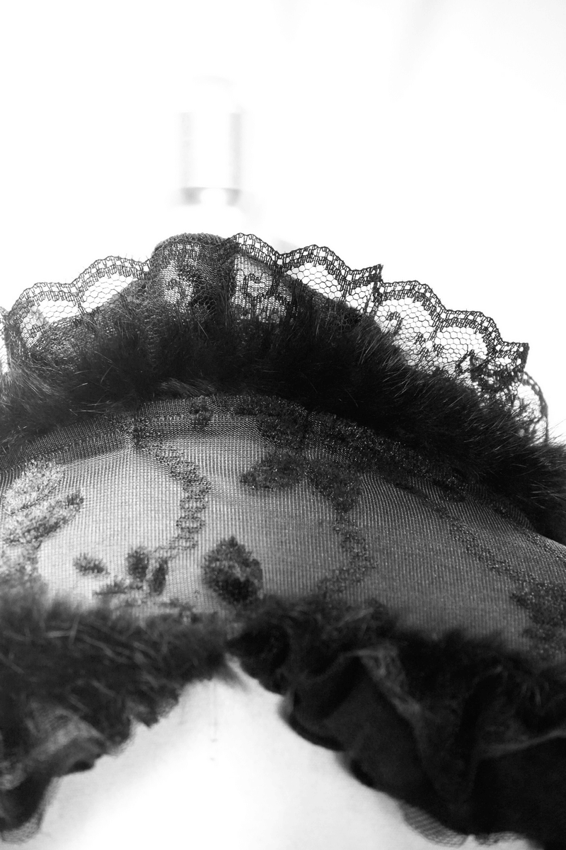 Close-up of a black lace ruffled bolero collar in gothic style, showcasing intricate detailing and vintage charm.