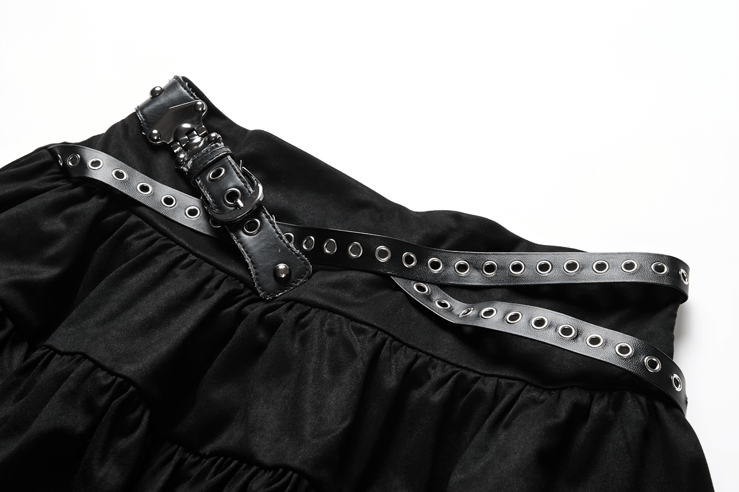 Close-up of gothic ruffled skirt showcasing the studded belt and layered fabric details.