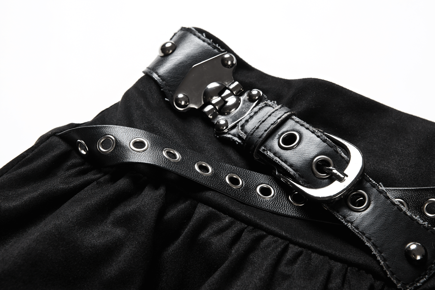Close-up of a black ruffled skirt featuring a studded belt with metallic accents for a gothic look.