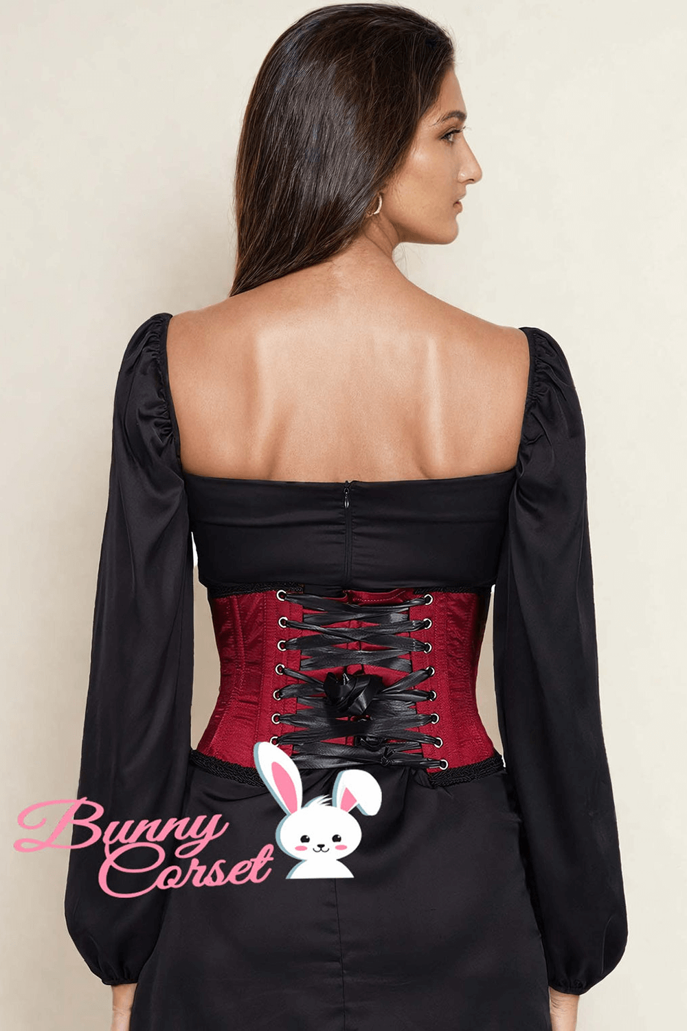 Woman showcasing a red underbust corset with lace-up back and satin finish, perfect for gothic style.