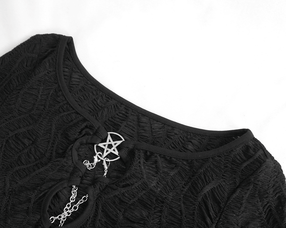 Close-up of gothic black crop top with elegant chain lace-up and pentagram detail.