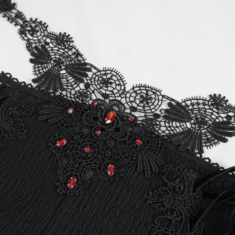 Close-up of black lace with floral patterns and red embellishments on a gothic women's garment.