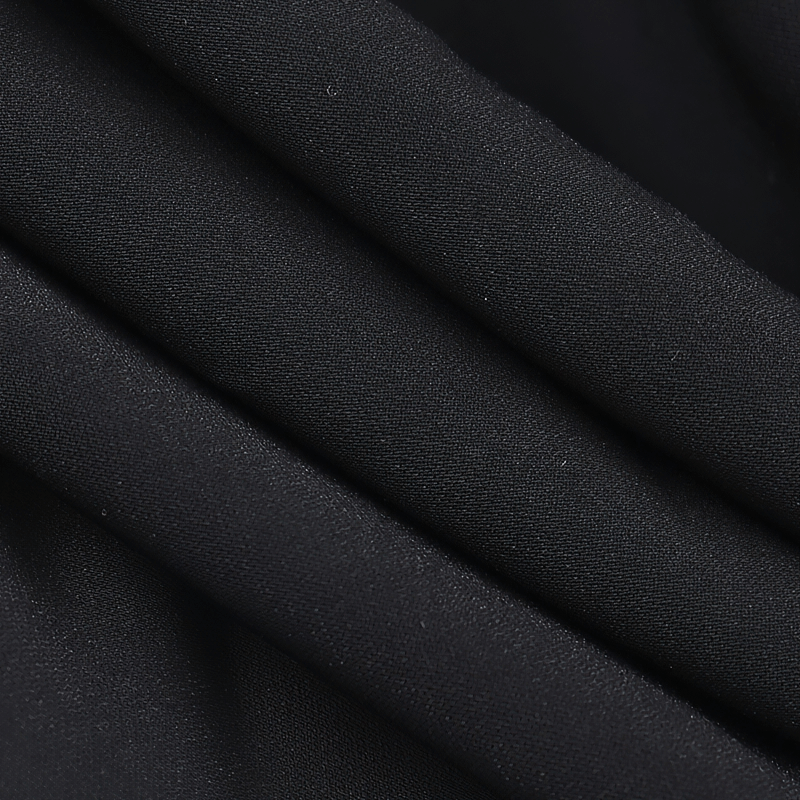 Close-up of soft black fabric showing elegant draping, perfect for gothic v-neck collar bolero and alternative fashion.
