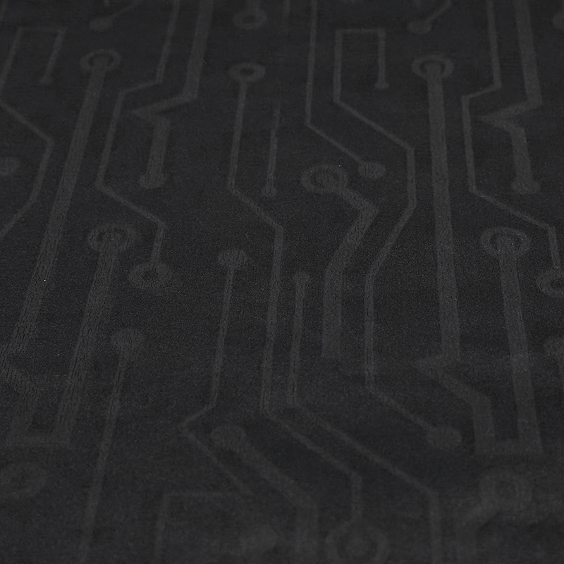 Textured black fabric with a modern circuit board design, perfect for tech-inspired fashion and accessories.